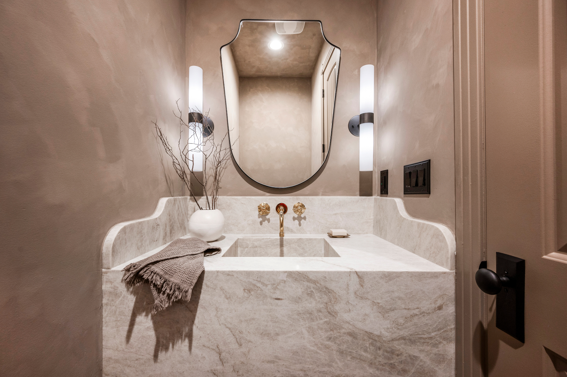 Natural stone powder room with marble vanity crafted by Creative Granite + Design